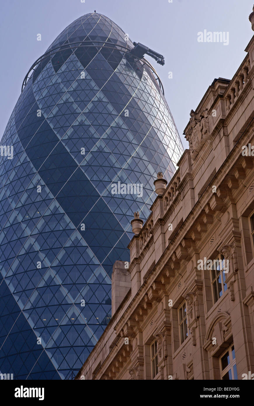 The classical architecture of St Helens Place contrasts with the Swiss Re tower (Gherkin) Stock Photo