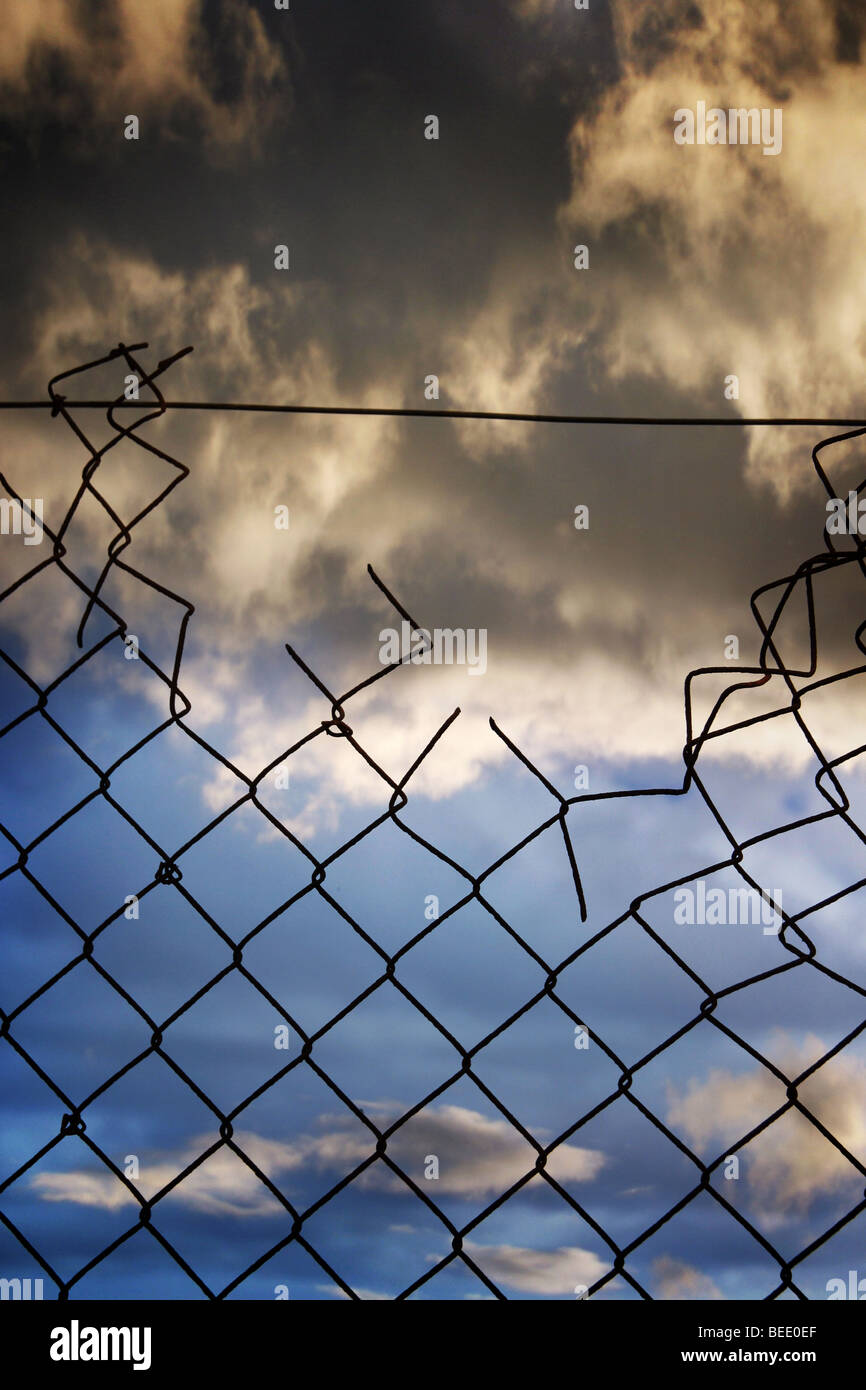 broken security fence Stock Photo