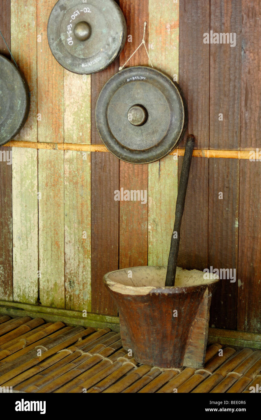Interior of Land Dayak or Bidayuh Communal Longhouse Terrace with Gongs Pestle & Mortar at Sarawak Cultural Village Kuching Sarawak Malaysia Borneo Stock Photo