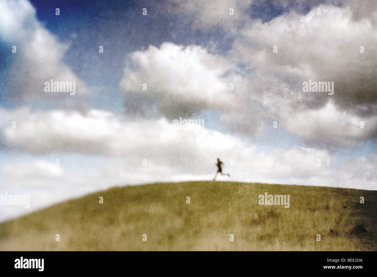 man running across the top of a hill Stock Photo