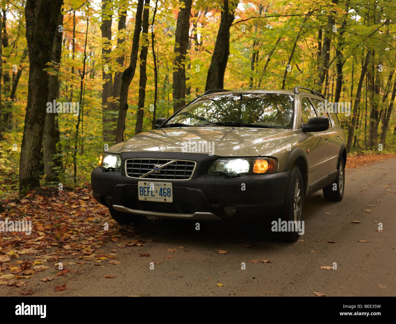 Volvo XC70 on a country road in fall nature scenery. Stock Photo