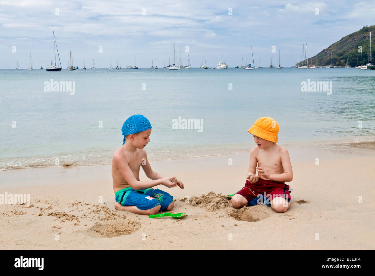 Two boys 5 and 6 years old playing on the beach Nai Harn Beach Phuket Island Southern Thailand Southeast Asia Stock Photo