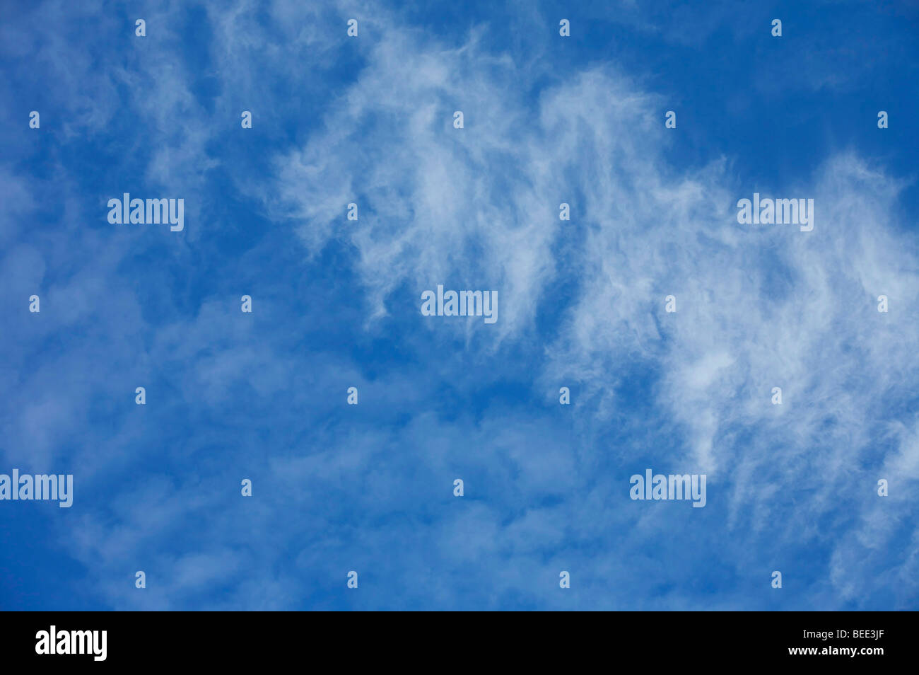 Bright blue sky with wispy white clouds Stock Photo - Alamy