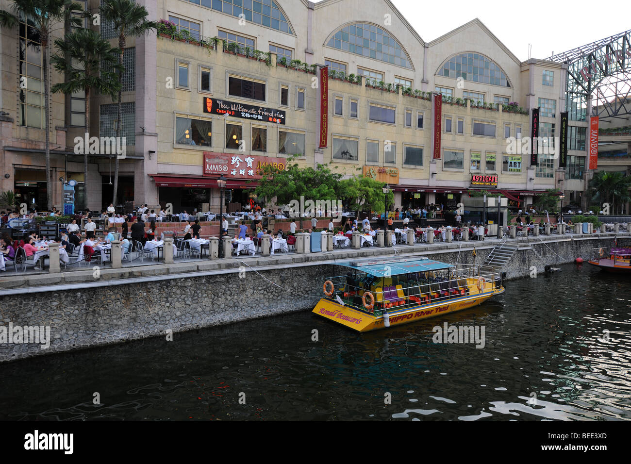 Jumbo Seafood Restaurant with people dining at outdoor riverside tables