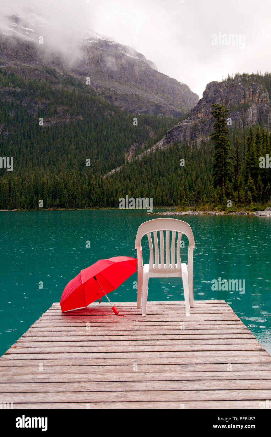 red umbrella with emerald lake water and dock Stock Photo Alamy