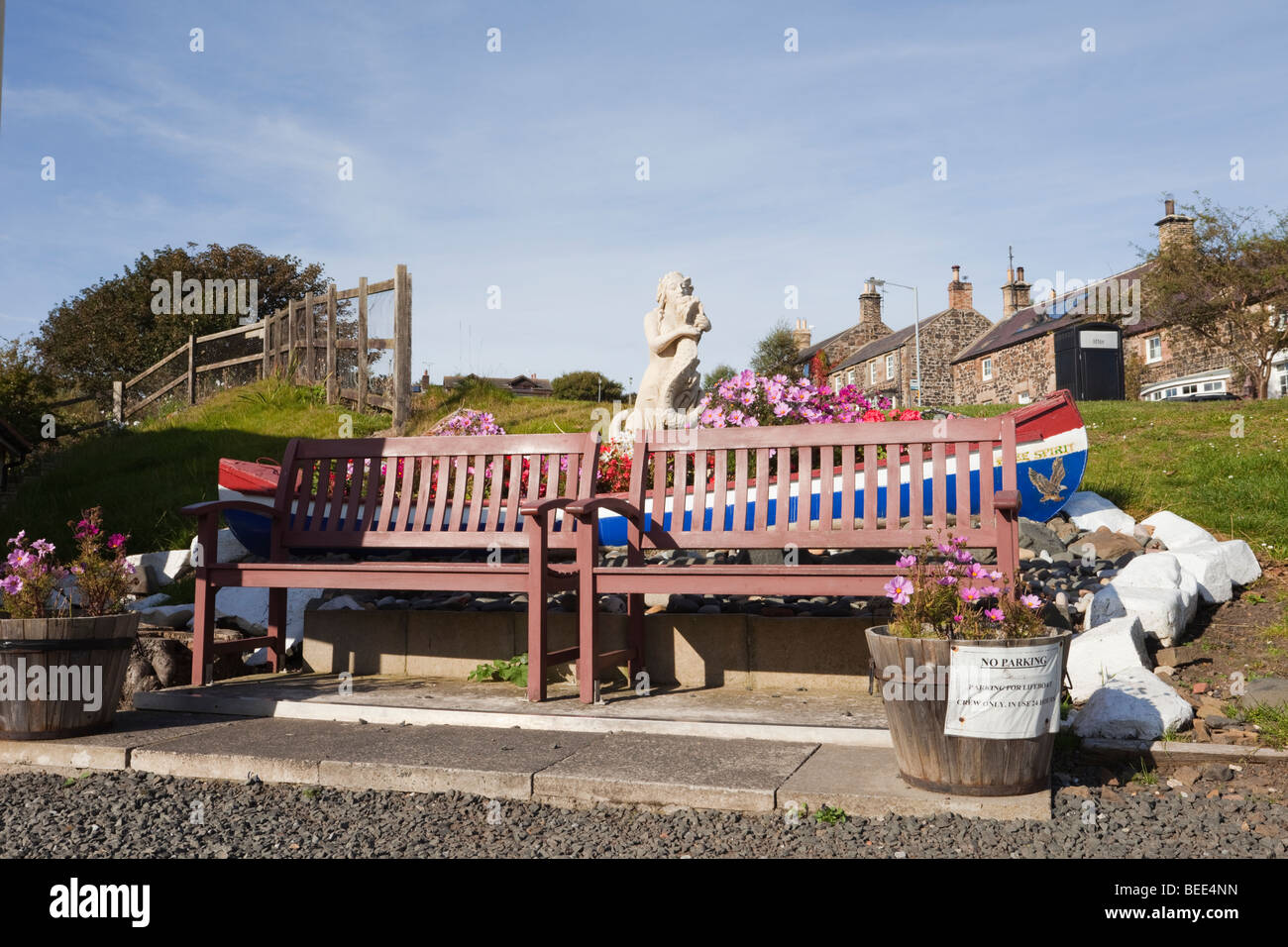 Craster, Northumberland, England, UK. Two empty memorial benches and
