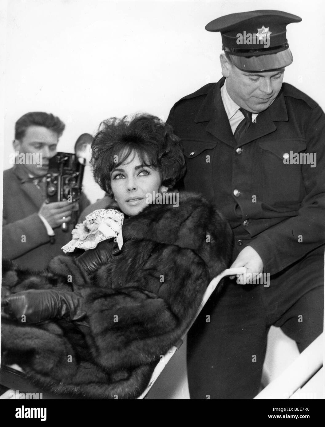Actress Elizabeth Taylor being pushed in wheelchair Stock Photo