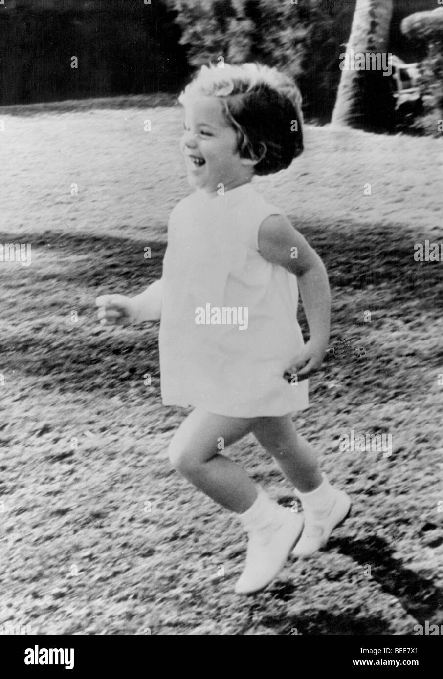 Young Caroline Kennedy running in the yard Stock Photo