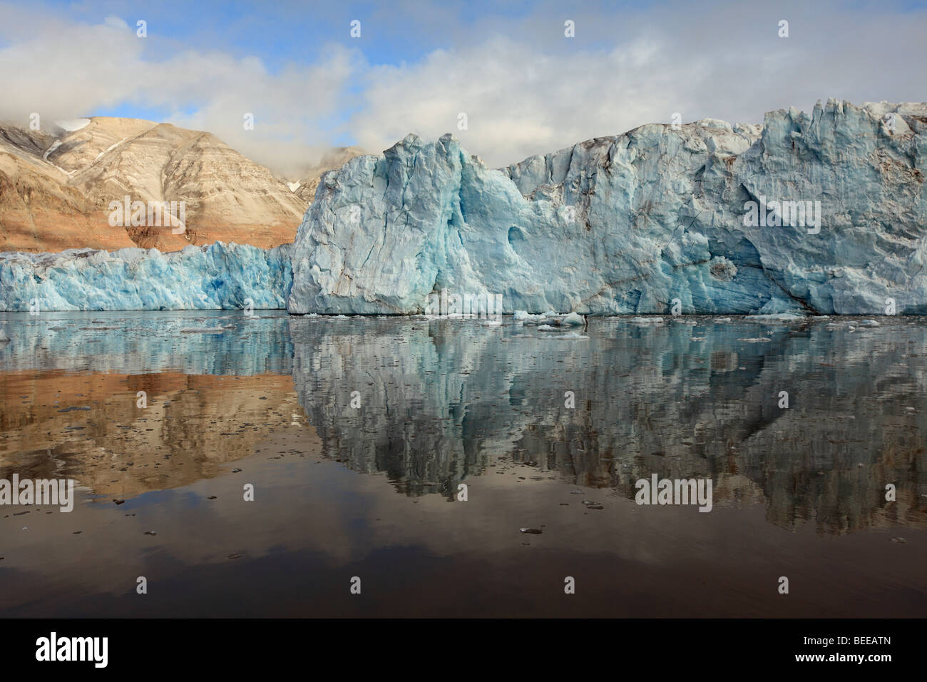 Arctic Glacier Reflected and Melting in Svalbard KongsFjorden Stock Photo