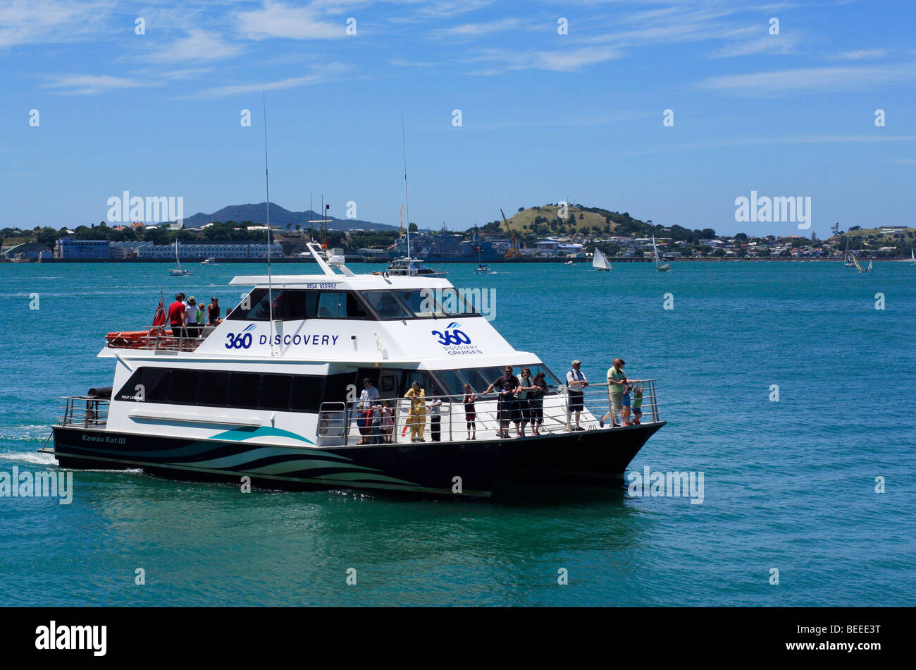 A sightseeing boat in Auckland Harbour, with Devonport in background. Auckland, North Island, New Zealand Stock Photo