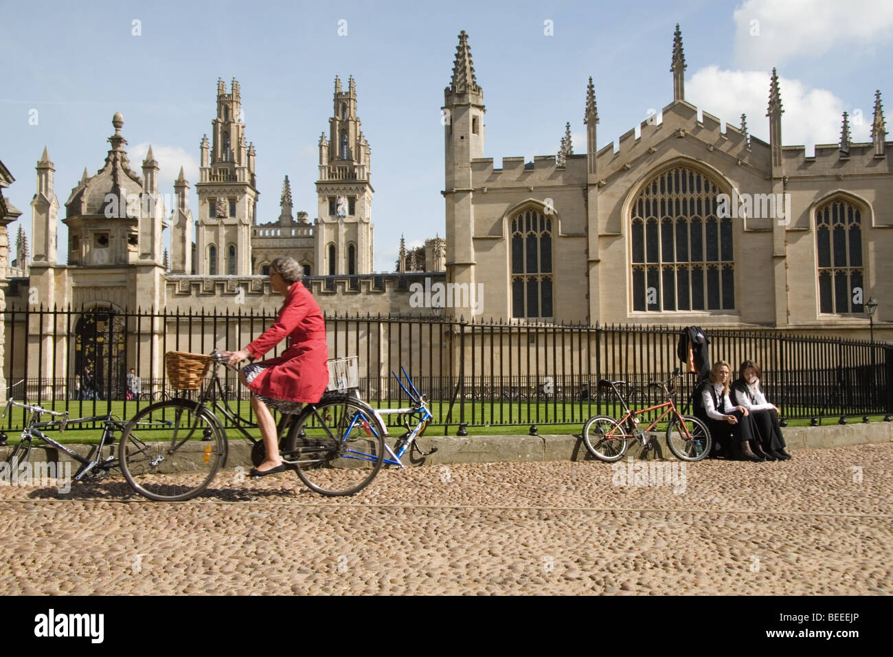 A woman rides a bike past All Souls College, Oxford: September 2009 Stock Photo