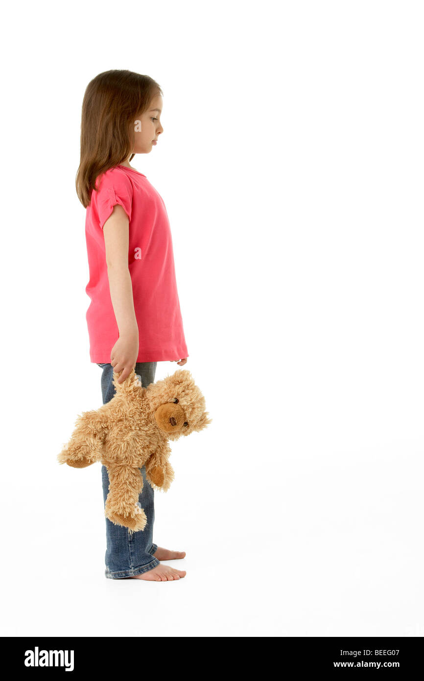 Studio Portrait of Girl Standing with Teddy Bear Stock Photo
