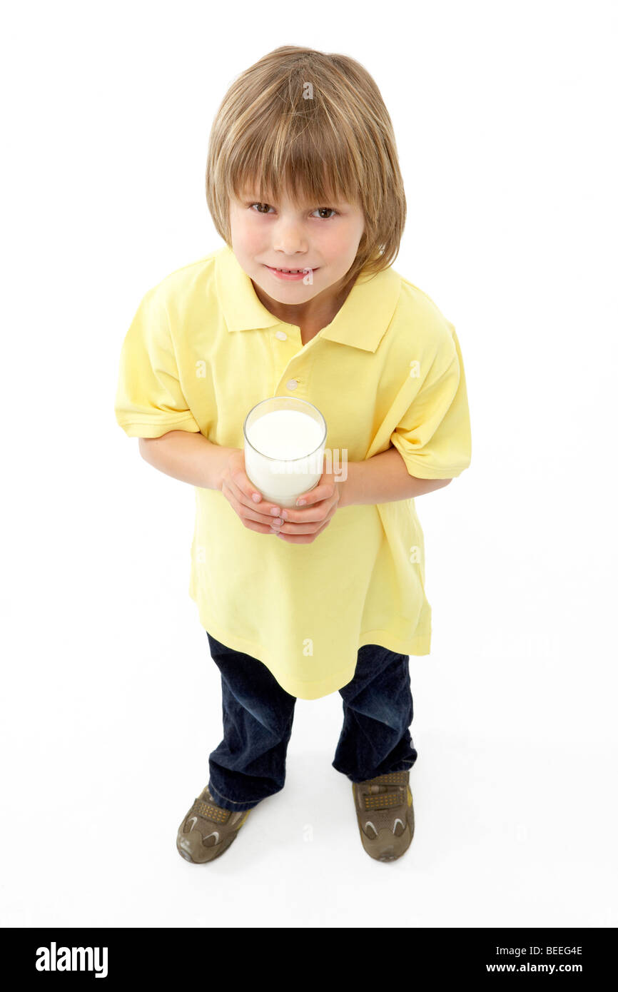 Studio Portrait of Smiling Boy Holding Glass of Milk Stock Photo