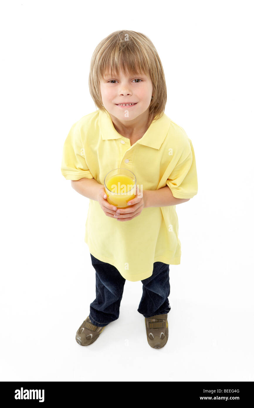 Studio Portrait of Smiling Boy Holding Glass of Fruit Juice Stock Photo