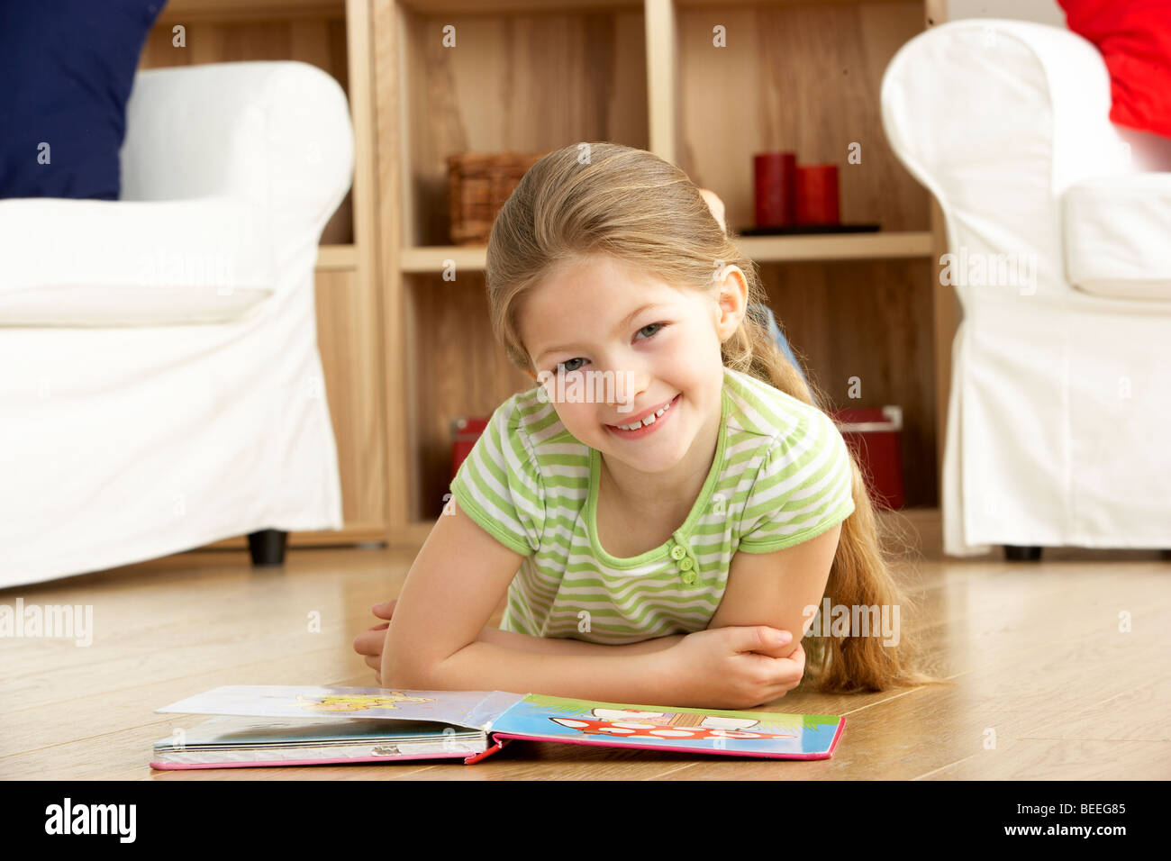 Young Girl Reading Book at Home Stock Photo - Alamy