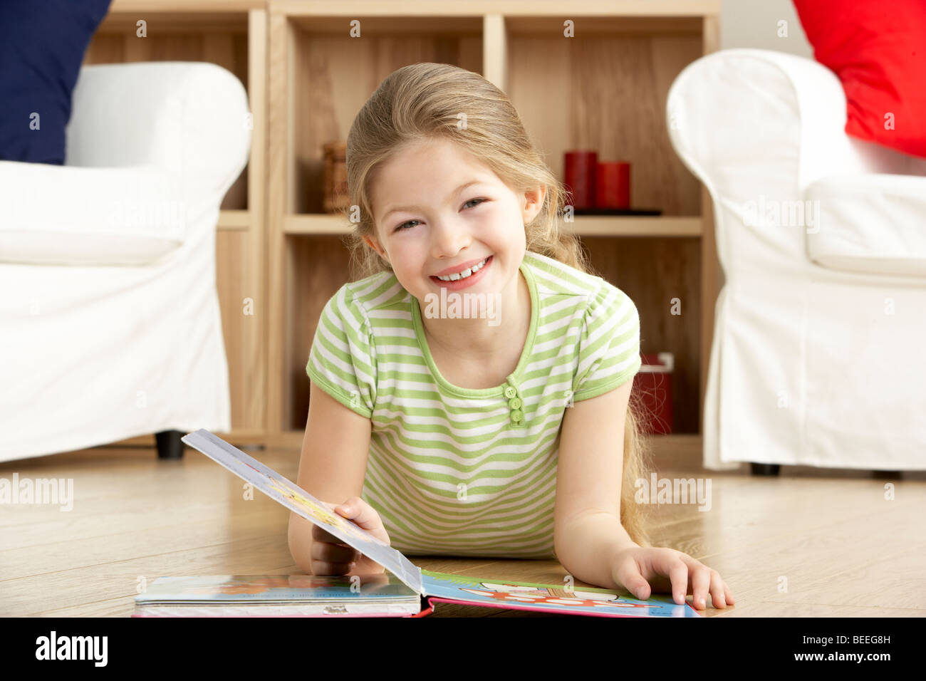 Young Girl Reading Book at Home Stock Photo - Alamy