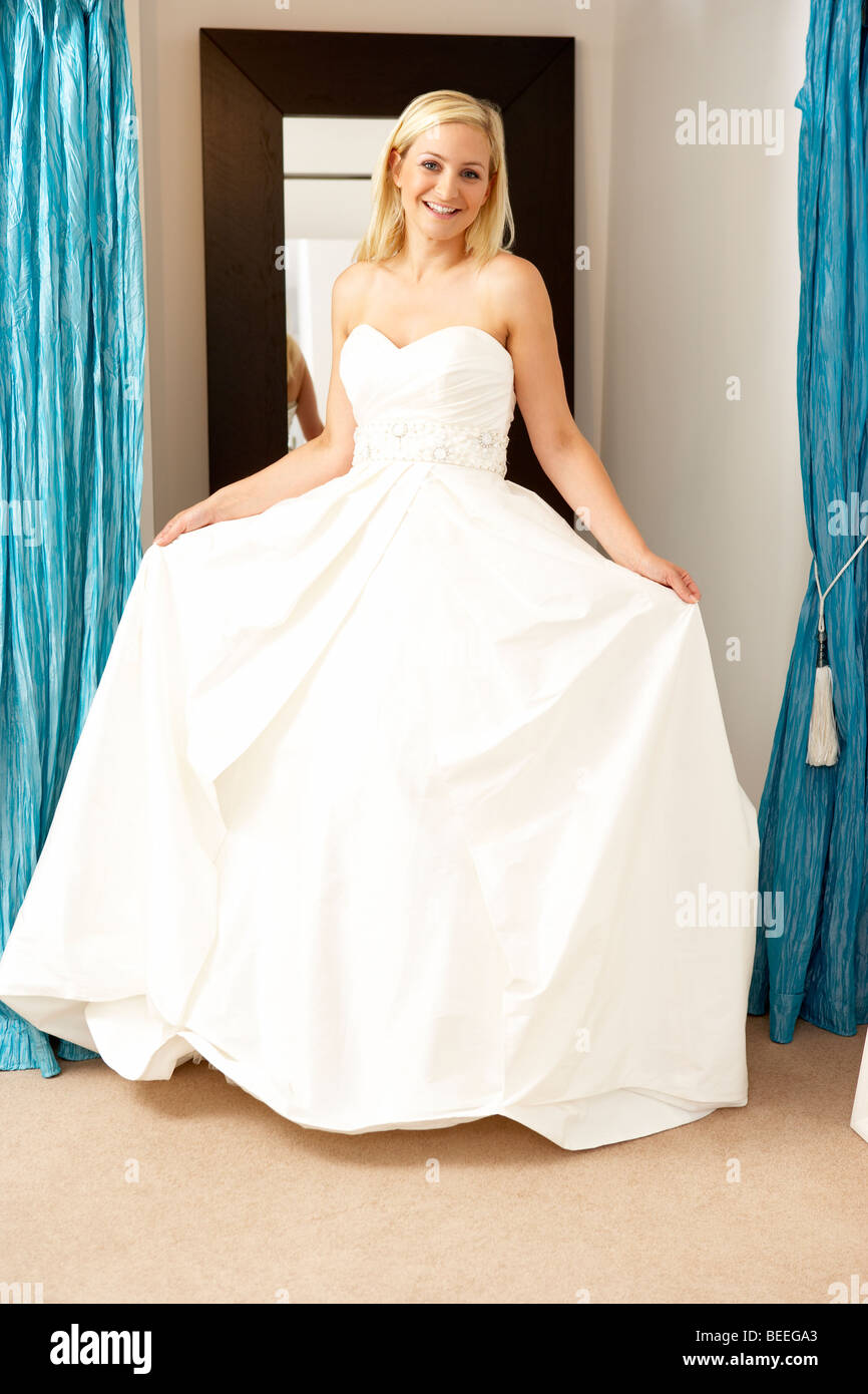 Bride trying on wedding dress Stock Photo