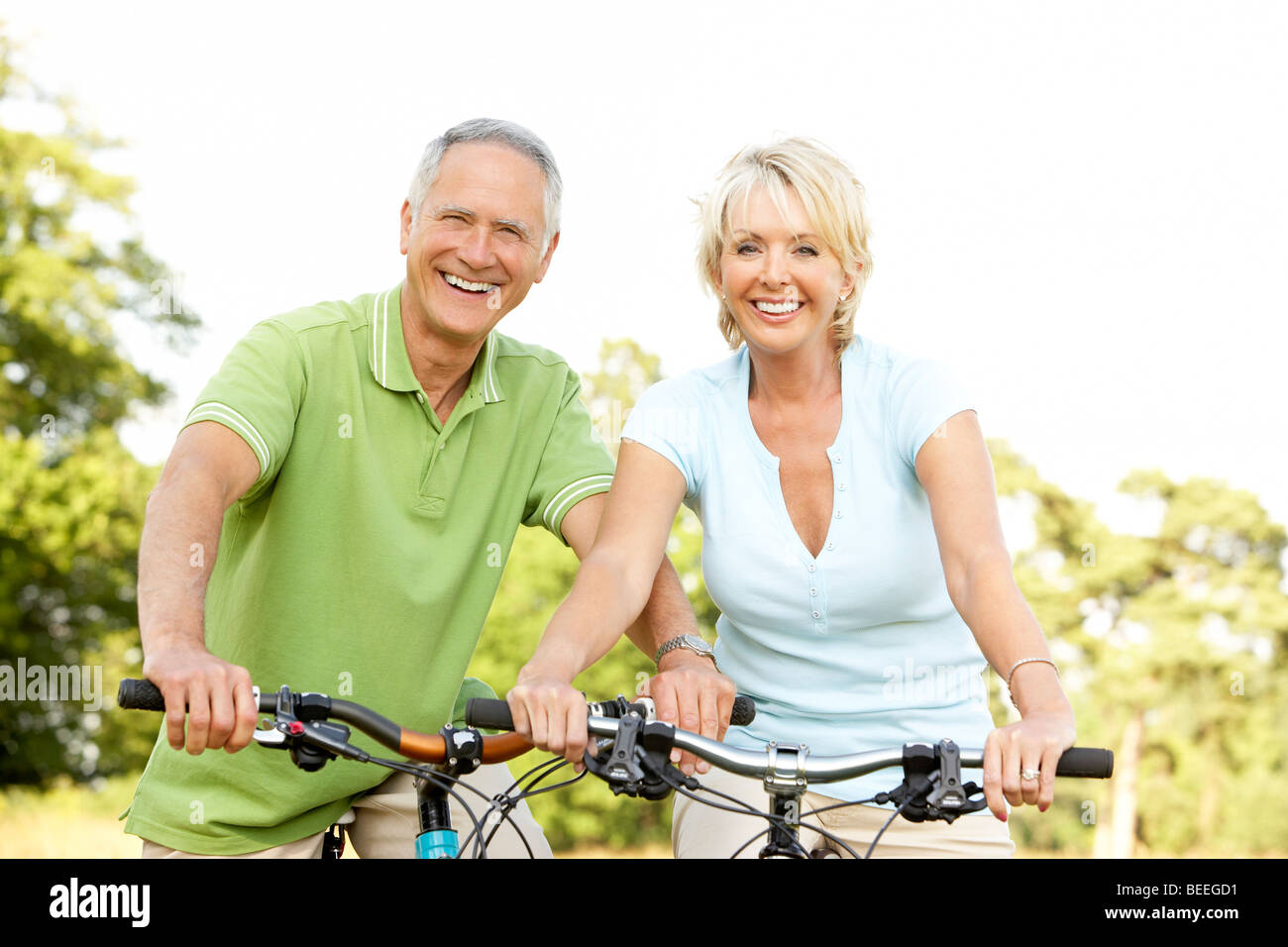 Mature couple riding bikes Stock Photo