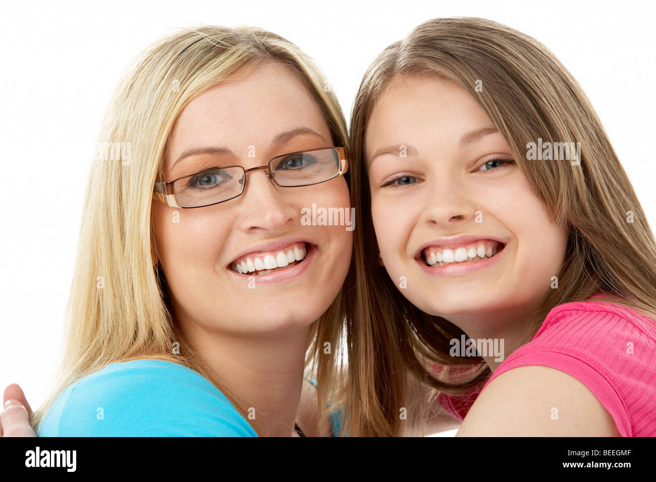 Studio Portrait of Smiling Teenage Girl with older Sister Stock Photo