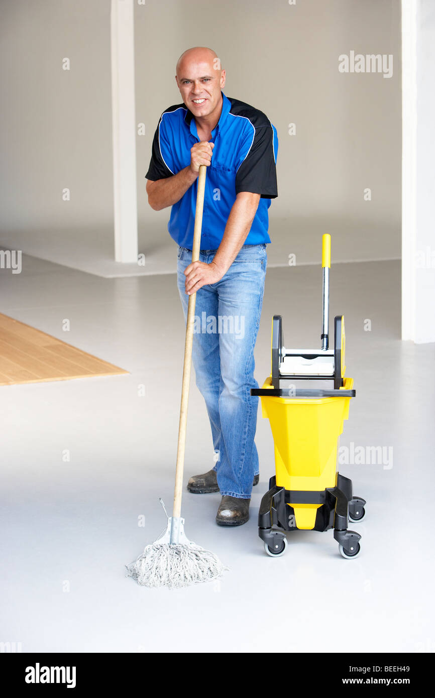 Cleaner mopping office floor Stock Photo