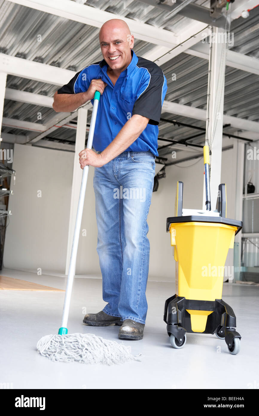 Cleaner mopping office floor Stock Photo Alamy