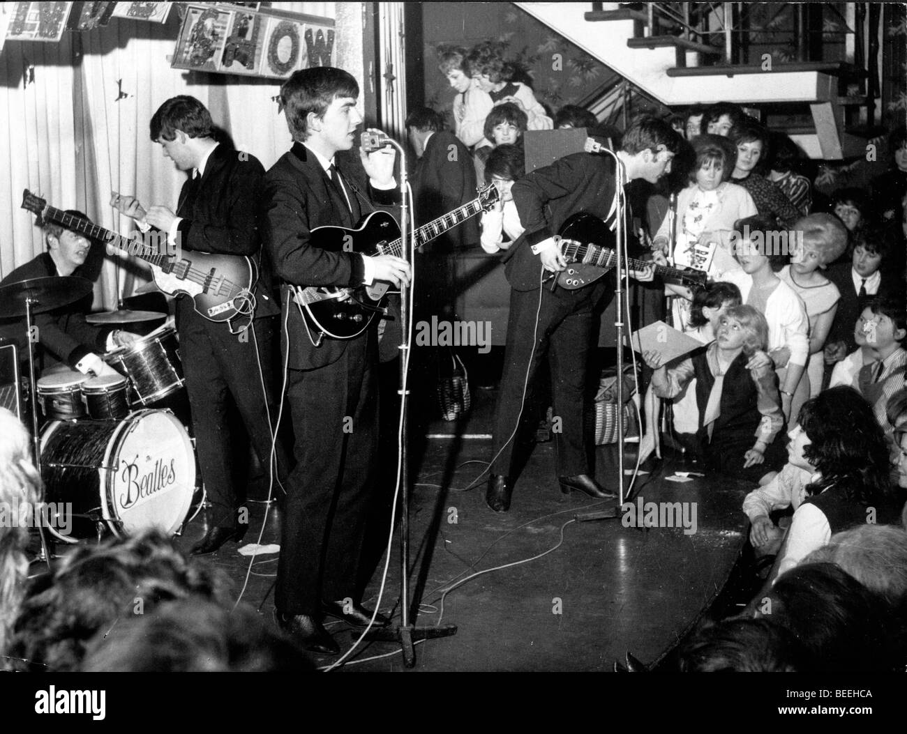 The Beatles (L-R) Ringo Starr, Paul McCartney, George Harrison, and John Lennon perform in a small club in 1962. Stock Photo