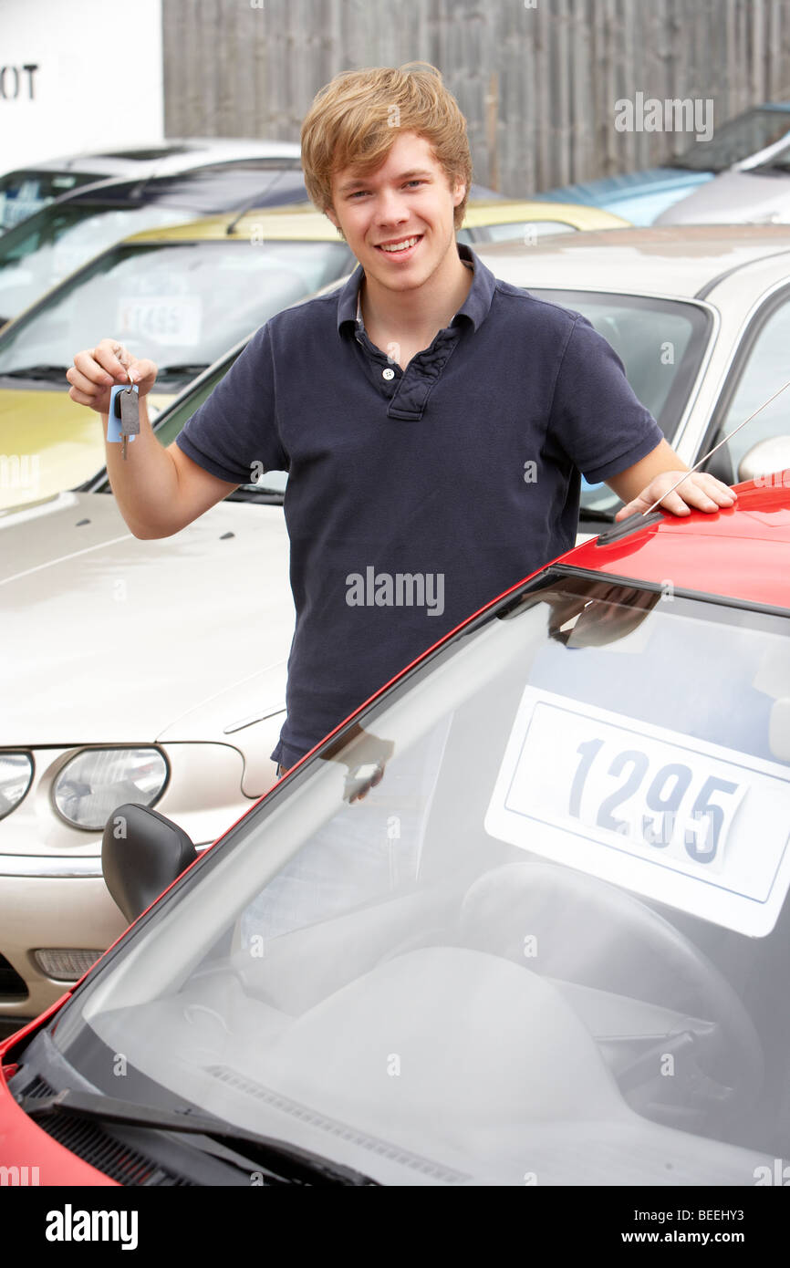 Young man collecting new car Stock Photo