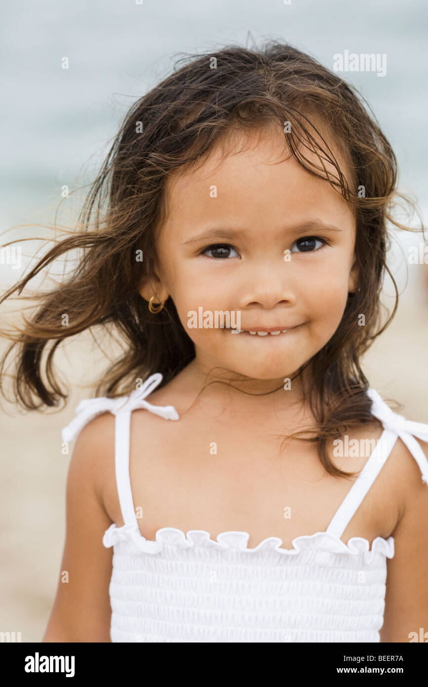 Mixed race girl smiling on beach Stock Photo Alamy