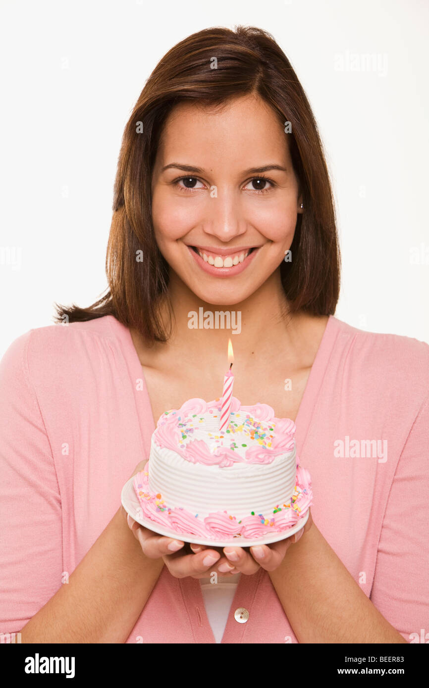 Hispanic woman holding birthday cake Stock Photo - Alamy