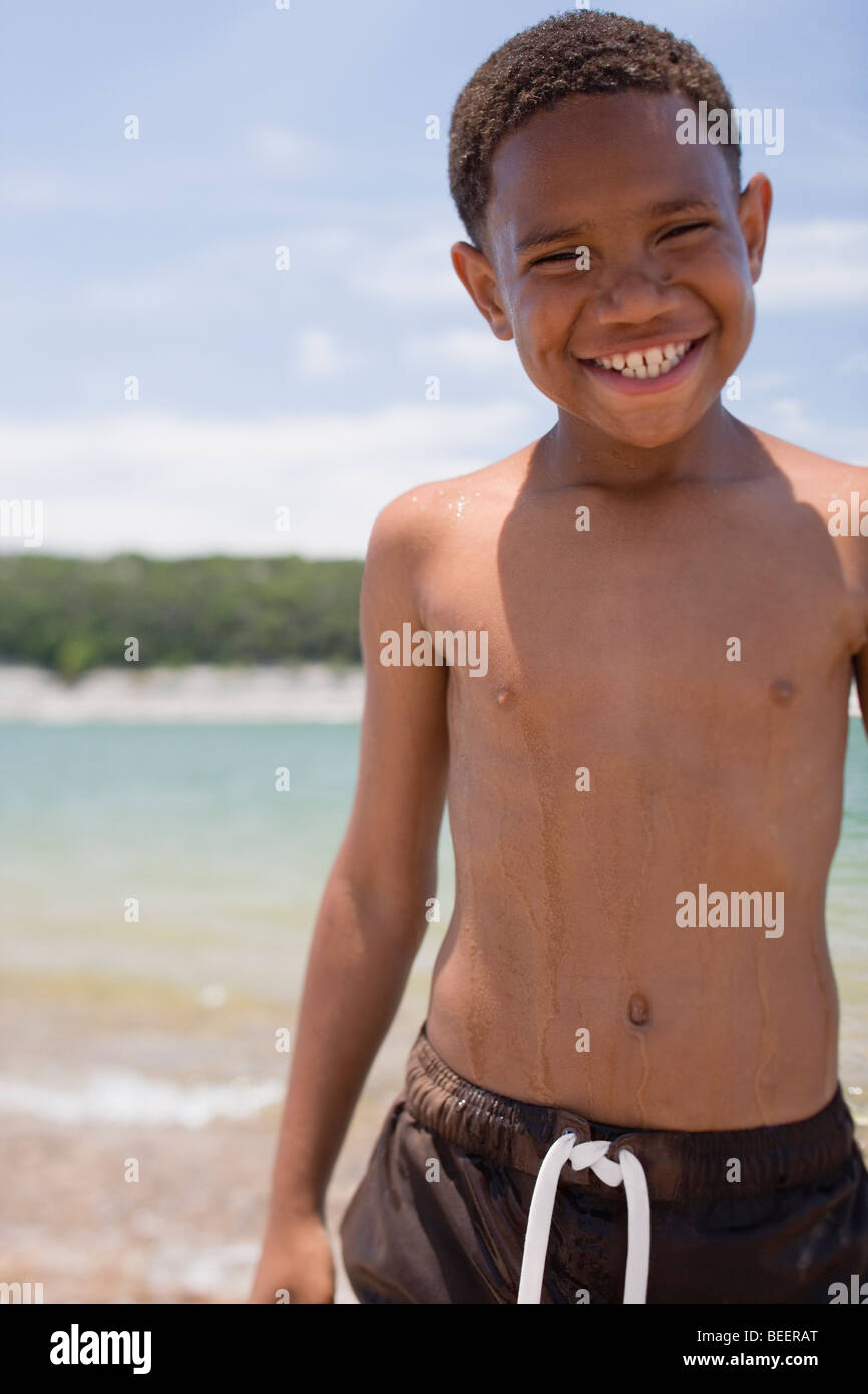 African boy wearing swim trunks on beach Stock Photo Alamy