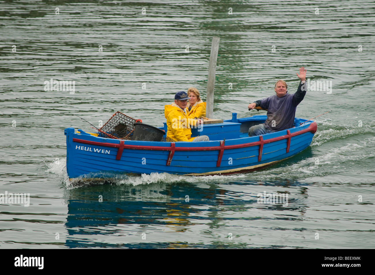 Three 3 Inshore lobster fishermen returning to harbour in a small boat with their catch, Aberystwyth Wales UK Stock Photo