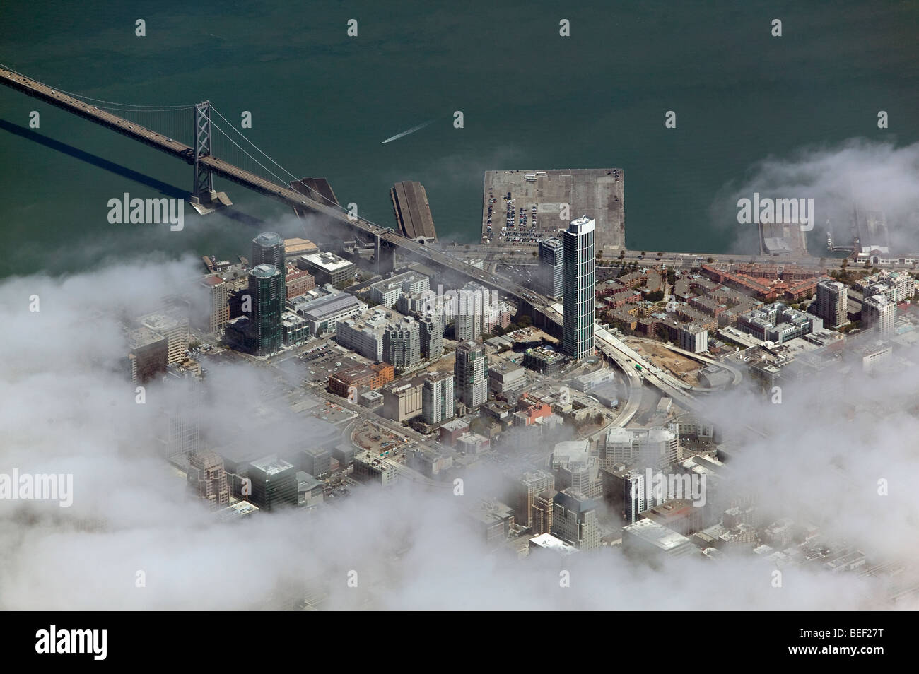 aerial view above One Rincon hill bay bridge 'San Francisco bay' through fog Stock Photo