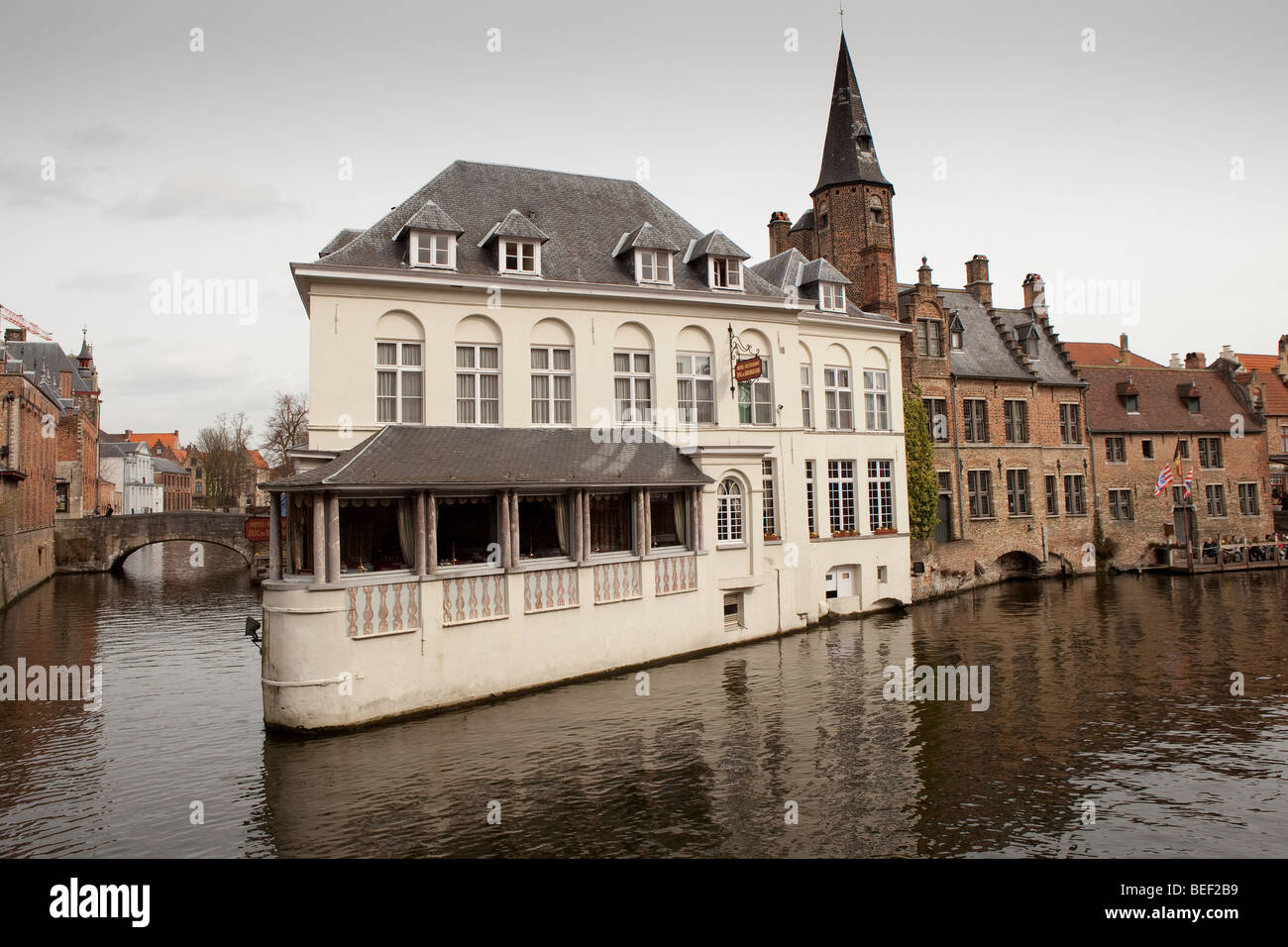 Historical buildings line a canal in Brugge, also known as Bruges, Belgium. Stock Photo