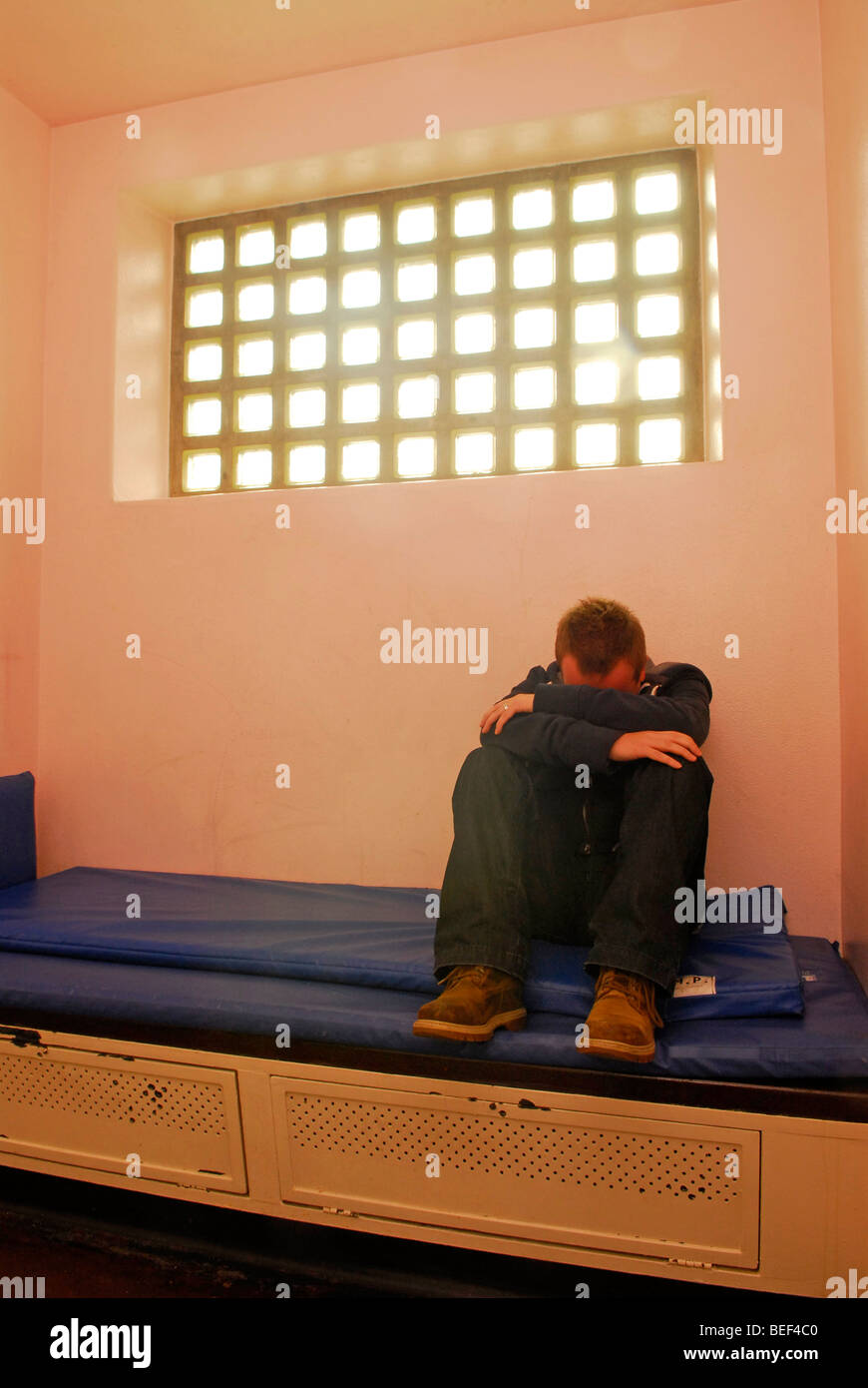 Man being held in police cell, Farnham, Surrey, UK. Posed by model. Stock Photo