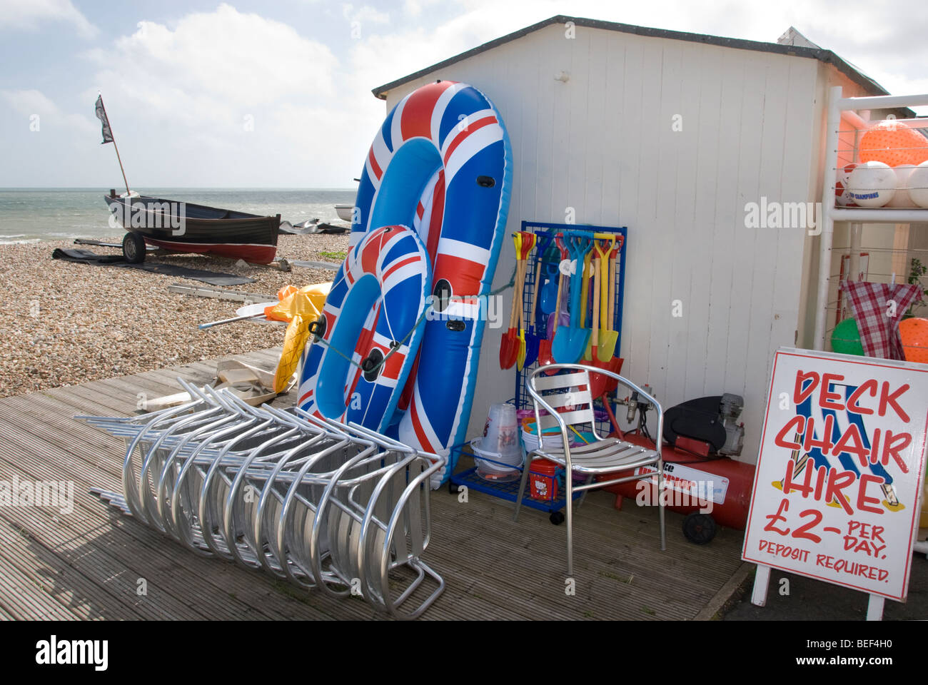 a beachside shop selling union jack inflatable boats, buckets and