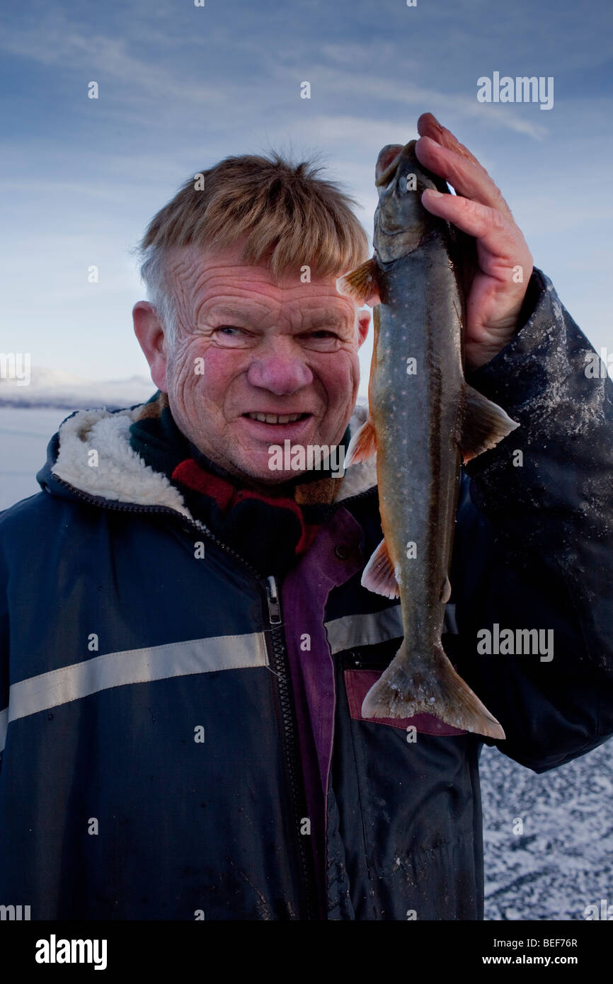 Man holding arctic trout, Lake Thingvellir, Iceland Stock Photo
