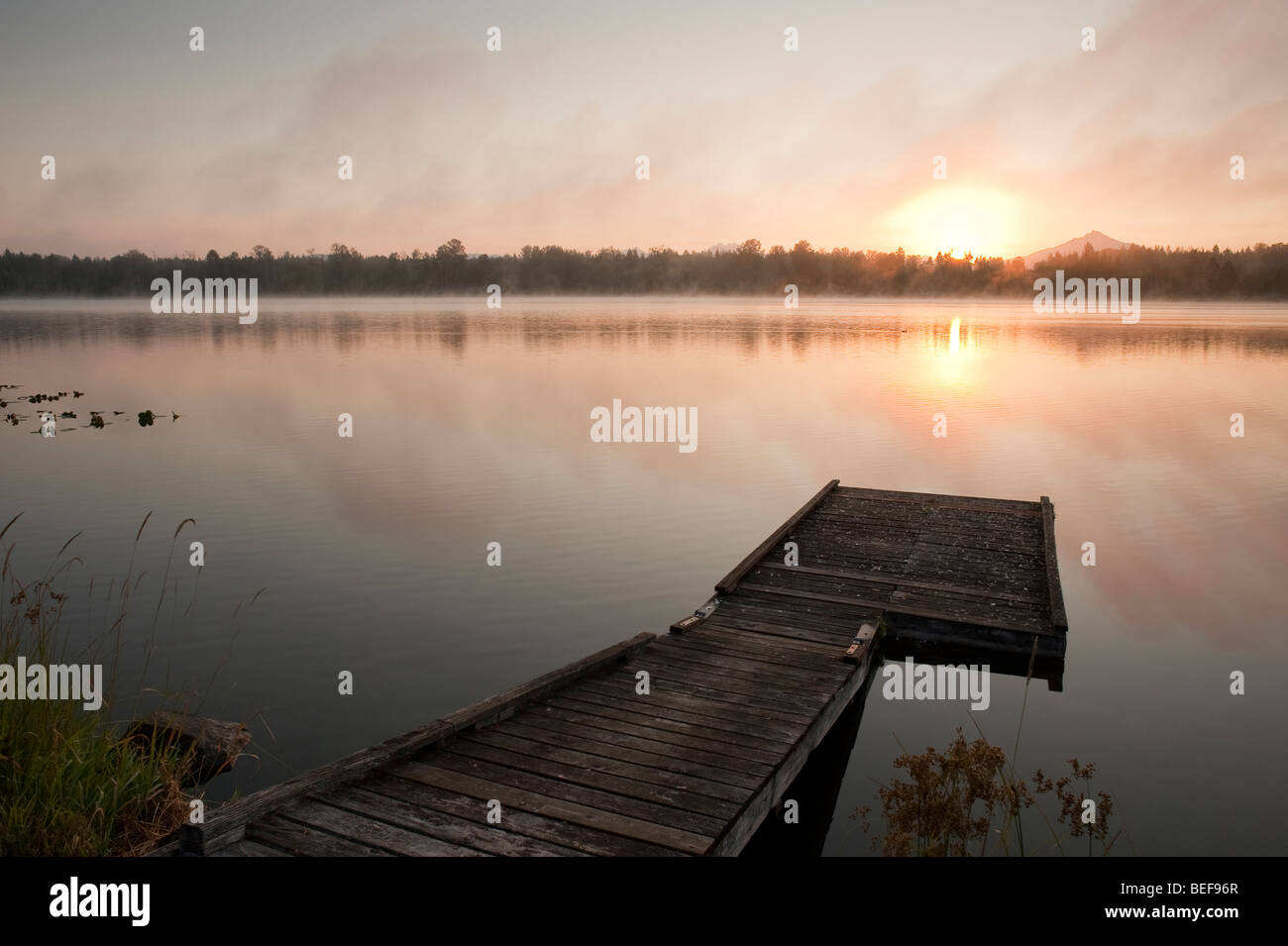 Sunrise at Lake Cassidy in fog with Mount Pilchuck and dock in ...