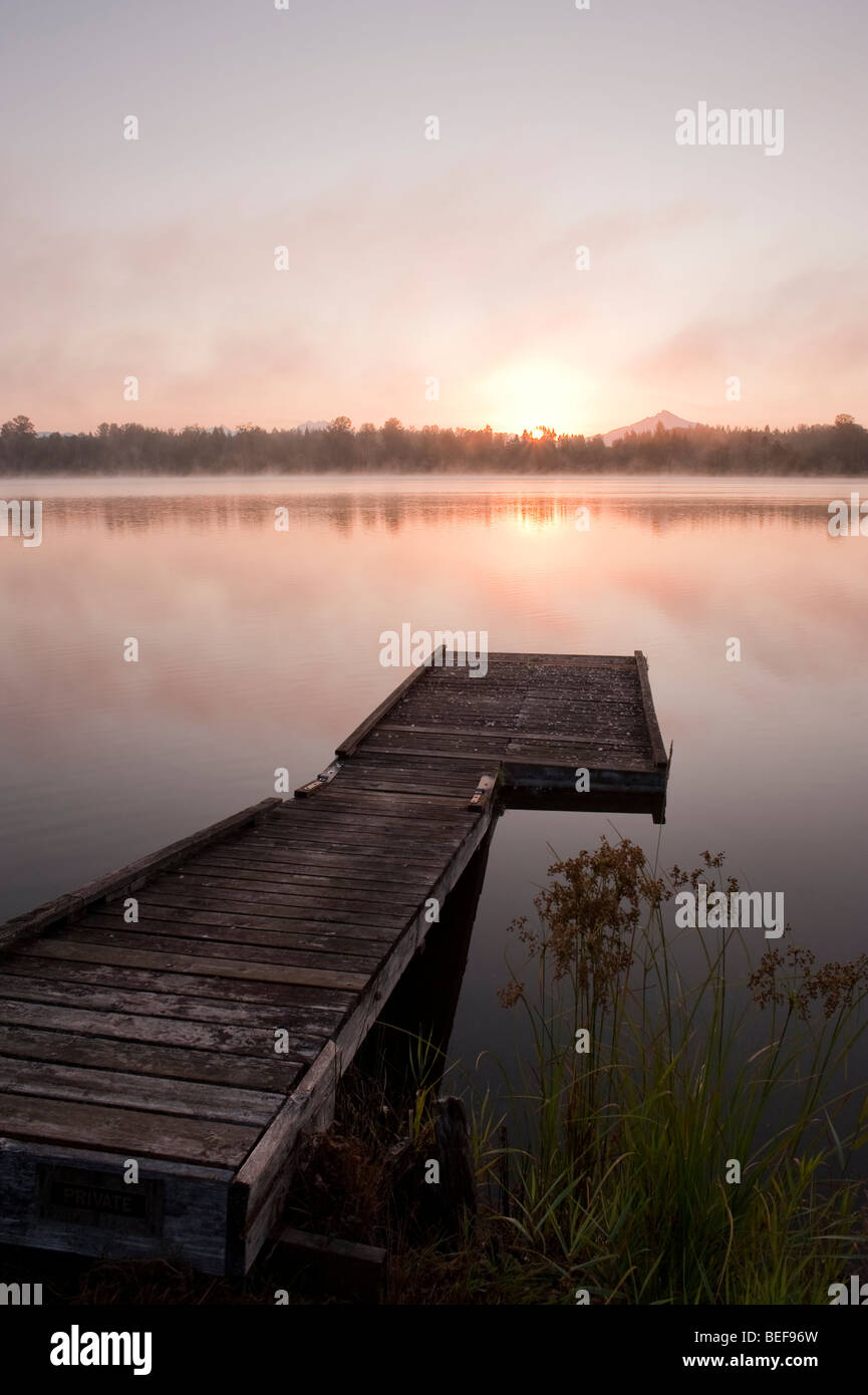 Sunrise at Lake Cassidy in fog with Mount Pilchuck and dock in