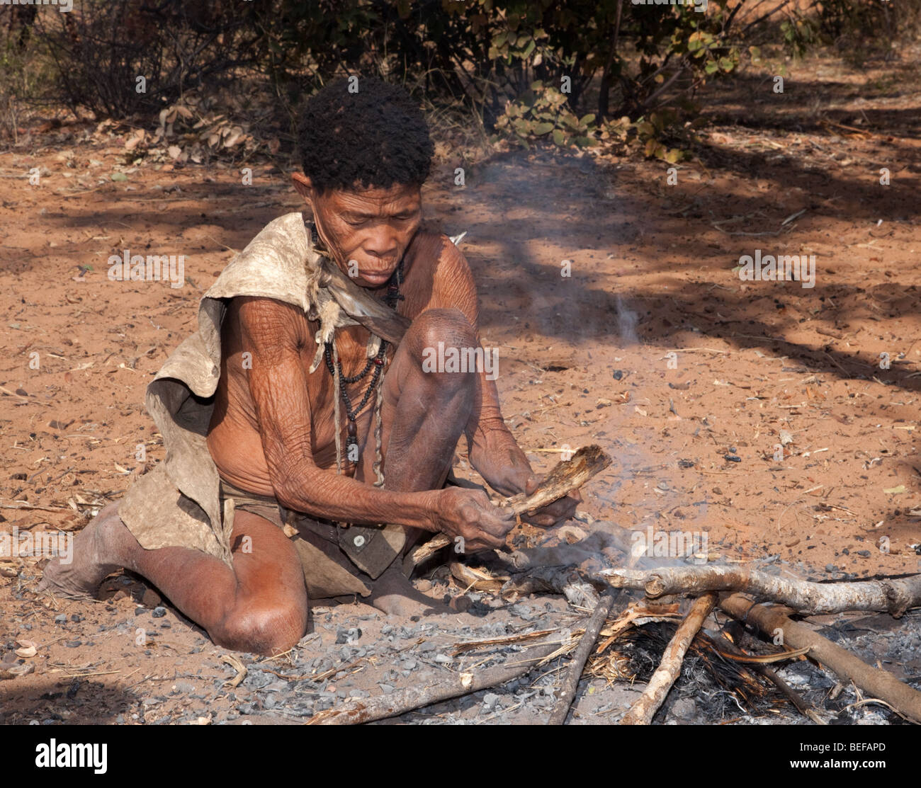 San Village. Making fire the old fashioned way. Stock Photo