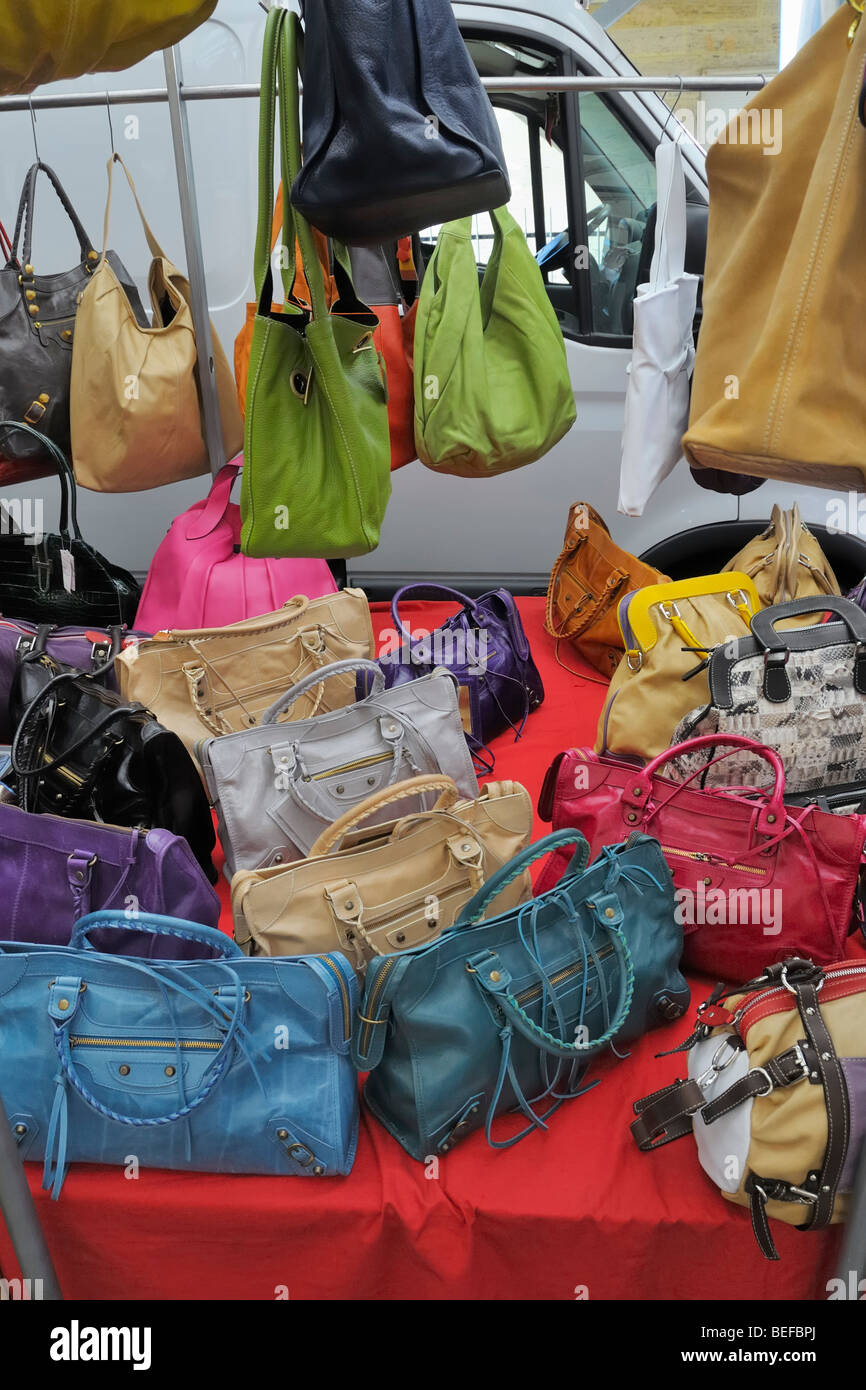 Leather handbags and purses on display for sale on the weekly open