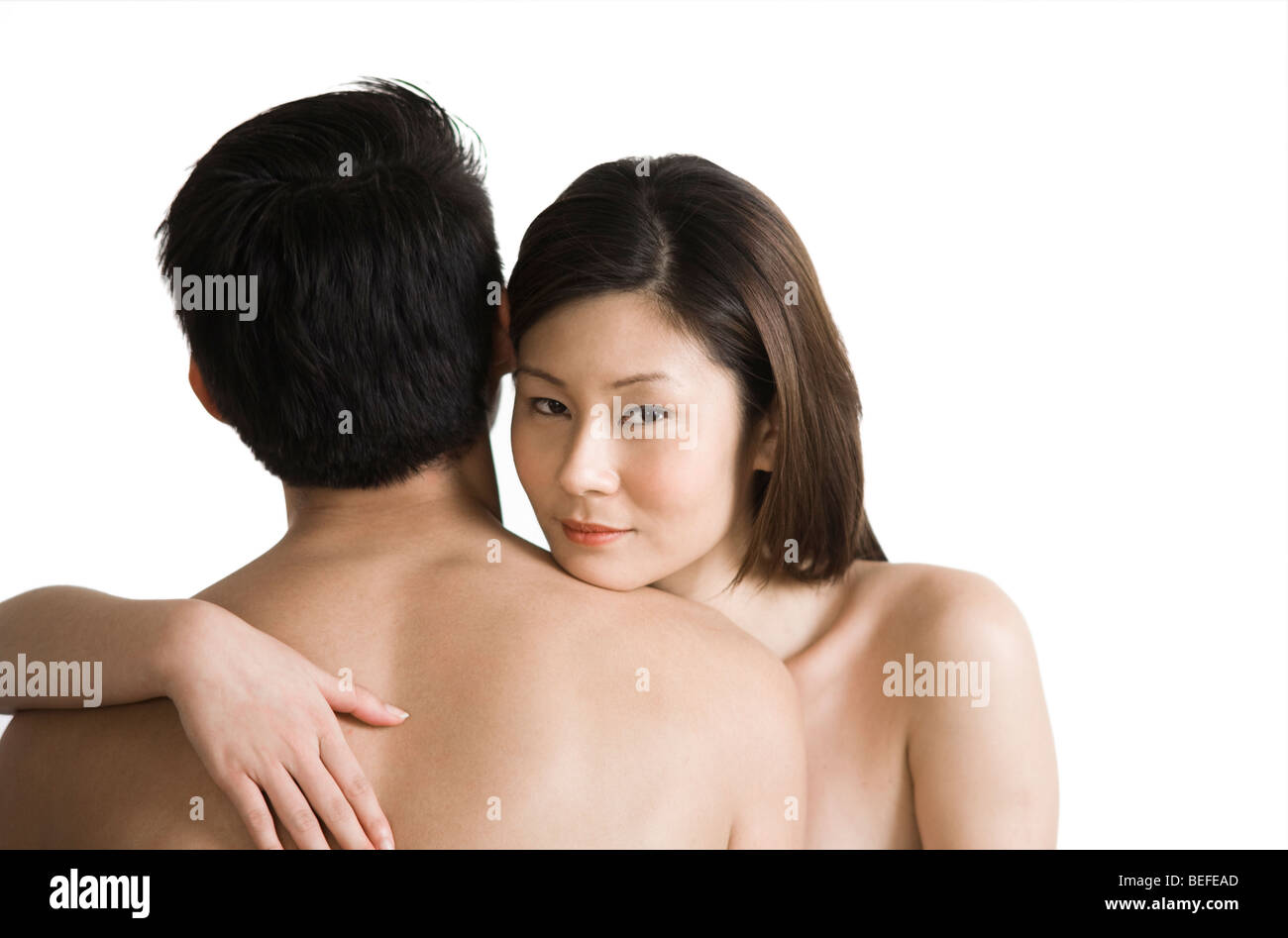 Woman holding man, man in rear view, portrait. Stock Photo
