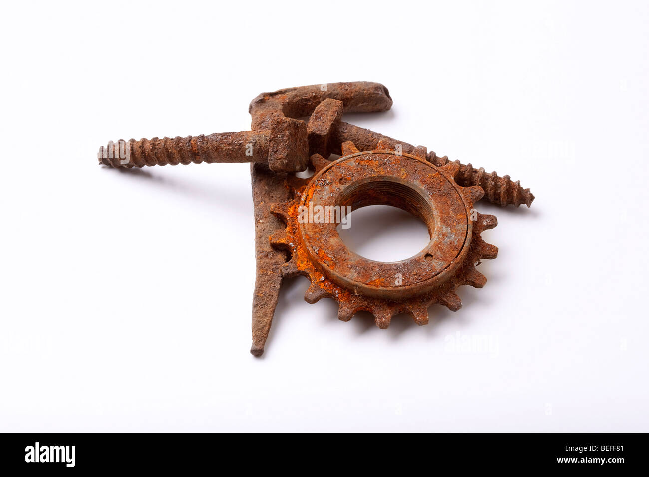 rusty old bolts and cogwheel isolated on white background - clipping path Stock Photo