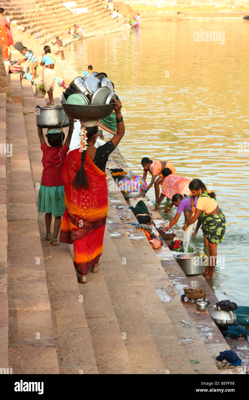 Indian women washing dishes in traditional way Stock Photo