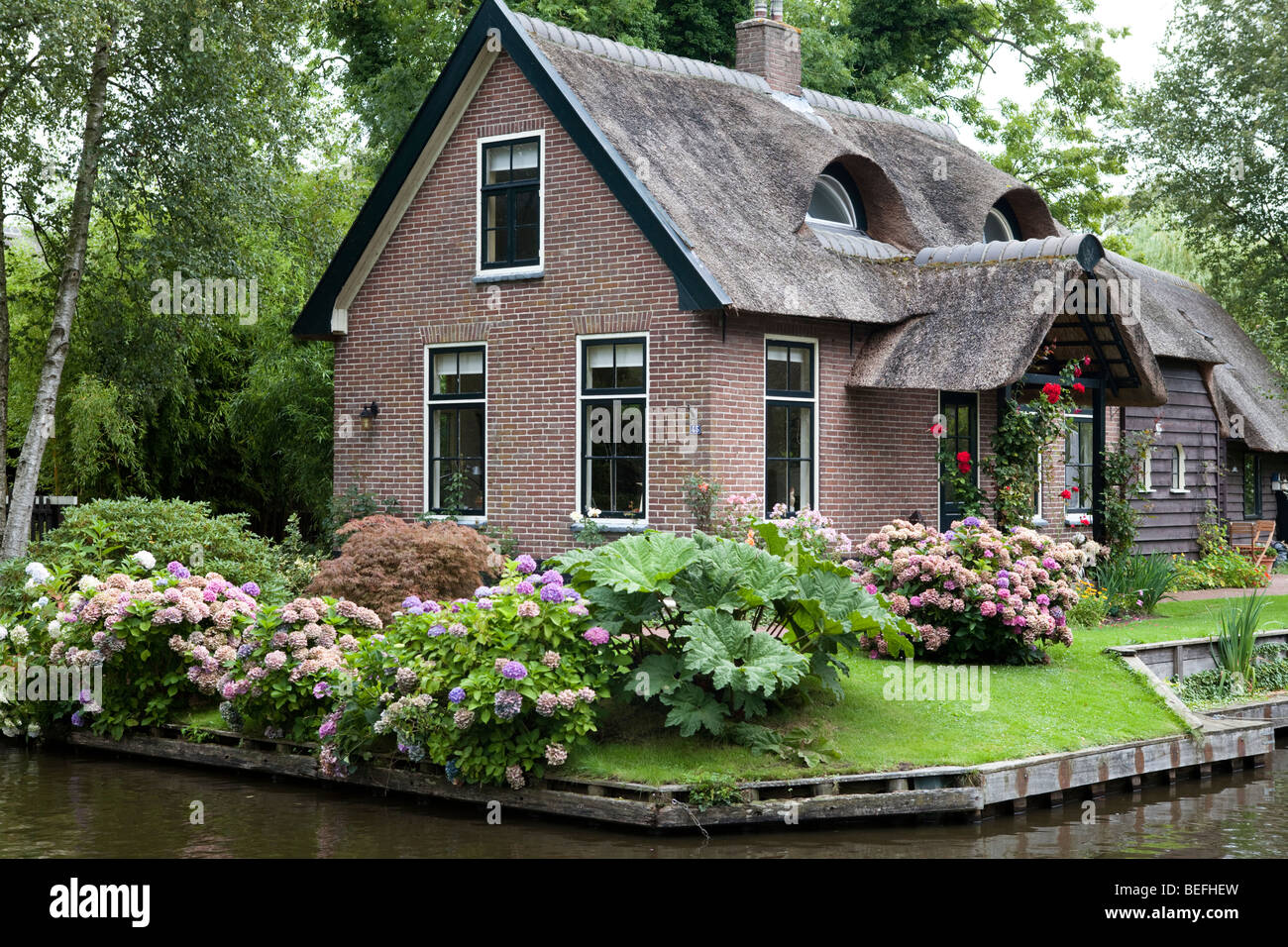 Traditional small village with red brick houses and canals: Giethoorn, the Netherlands. Stock Photo