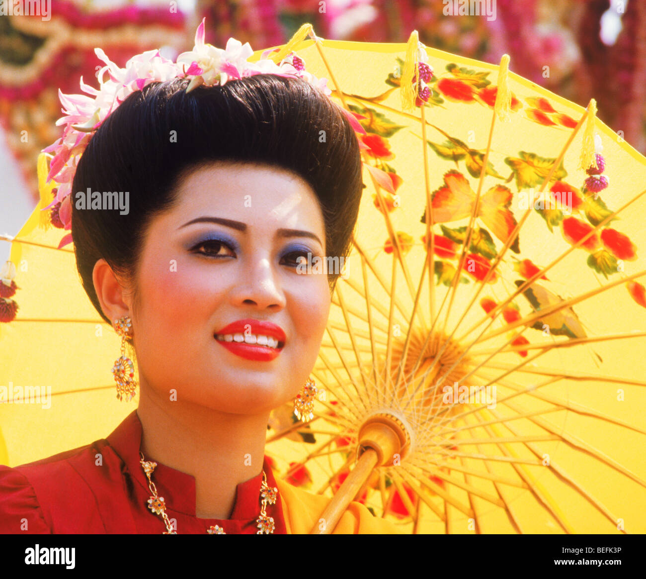 Beautiful Thai woman surrounded by painted umbrellas in Chiang Mai in Northern Thailand Stock Photo