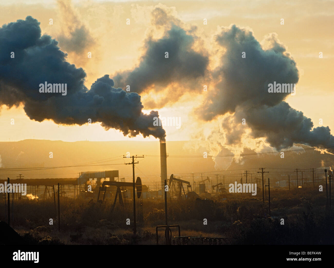 Oil Refinery Emitting Air Pollution at sunrise near Santa Rosa, California Stock Photo