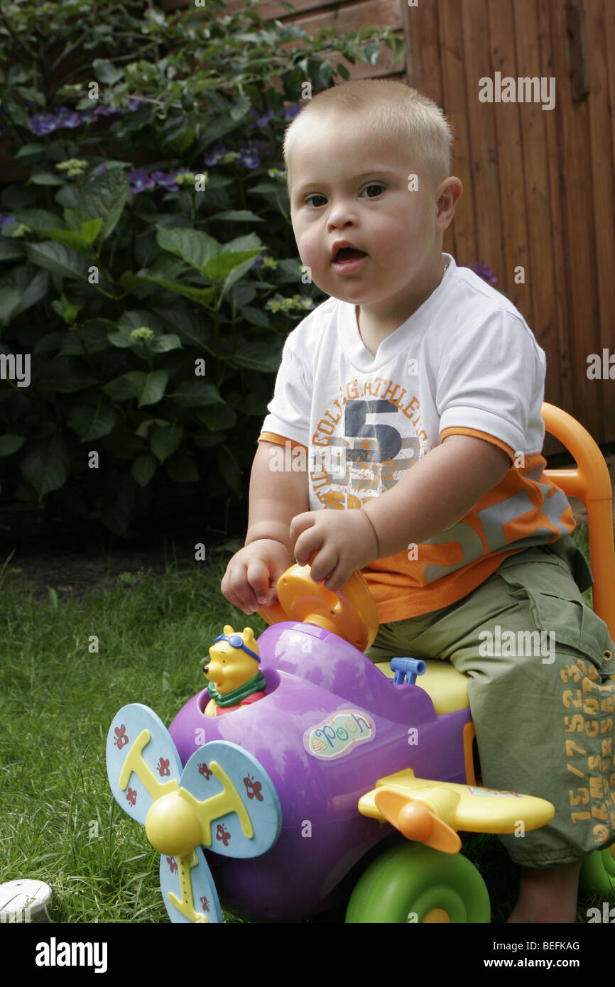 Down syndrome baby play with toy outside, SerieCVS217083 Stock Photo - Alamy