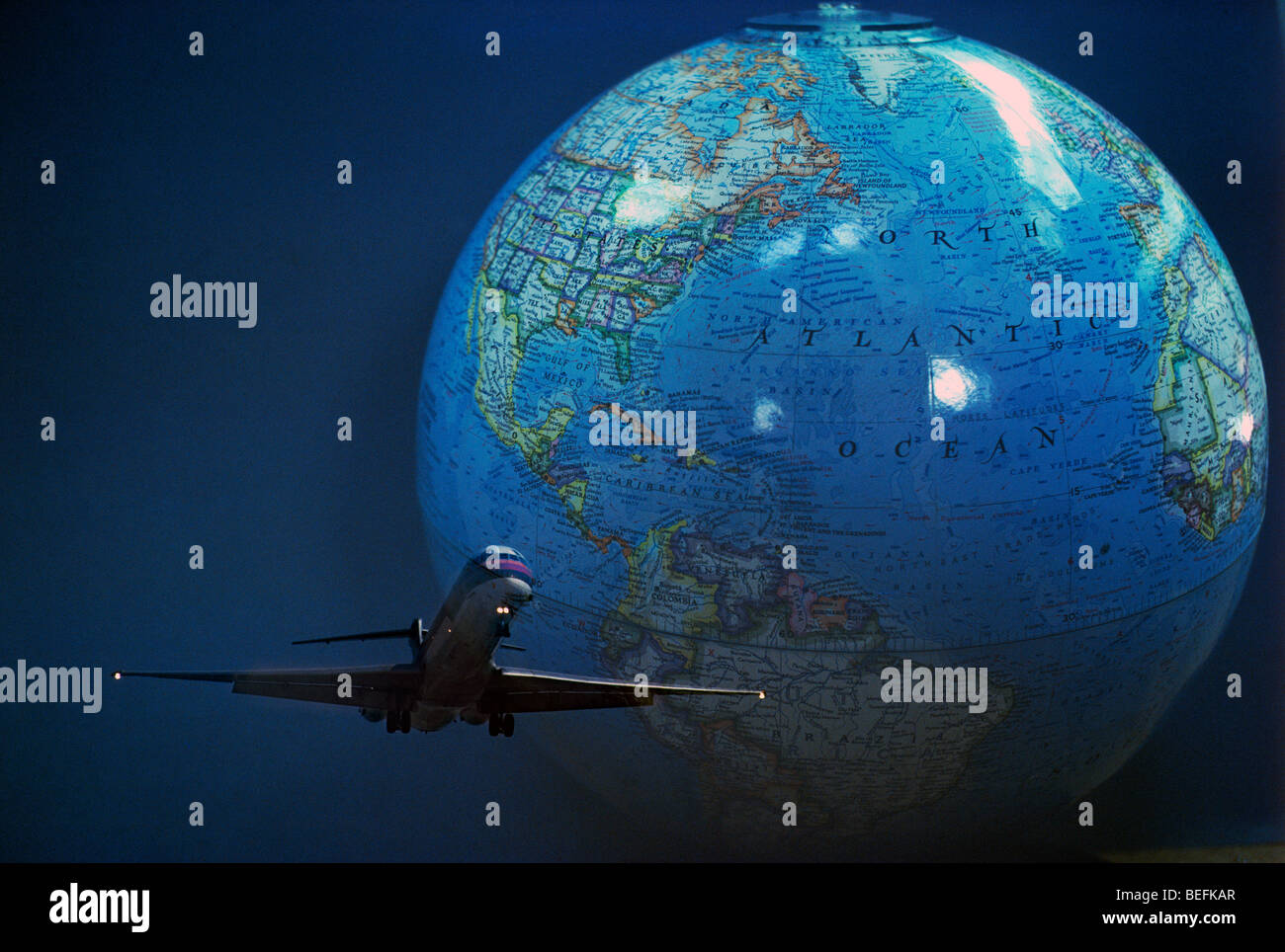 Airplane circling  globe symbolizing world travel Stock Photo