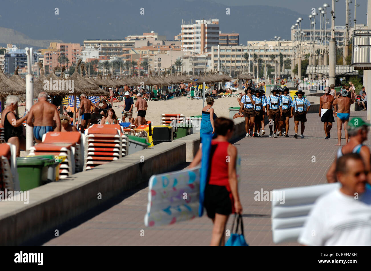 Majorca, Spain, Playa de Palma, Arenal.Oberbayern promotion. men walking down the beach bith bavarian dress. Stock Photo