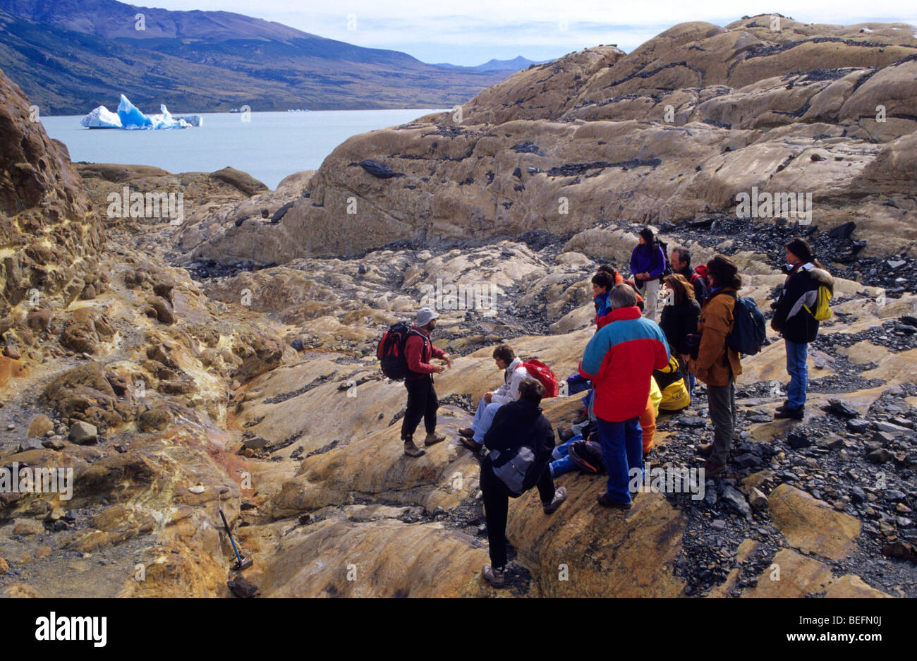 A guide gives instructions to a group of of tourists before beginning a trekking on the glacier Viedma. El Chalten. The Glaciers Stock Photo